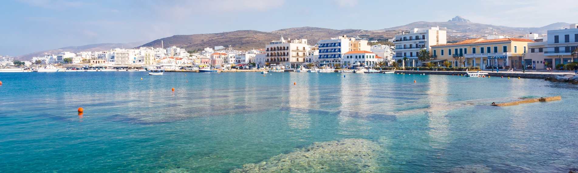 Transparent water, blue sky and white houses in Tinos, the Cyclades.